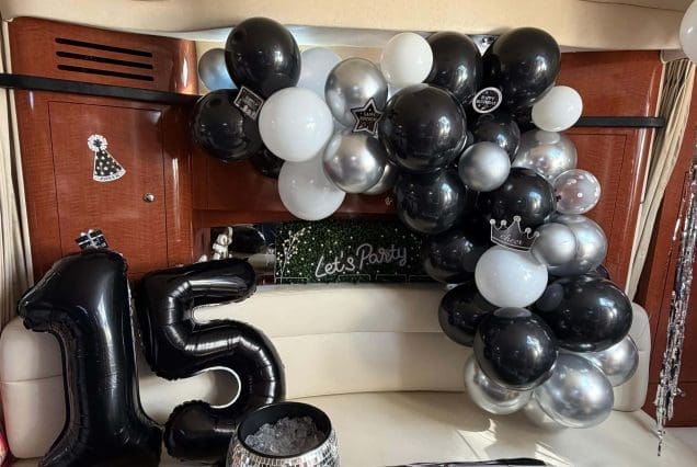 37ft Sea Ray E$Z Miami welcoming indoor salon with comfortable seating and modern styling and birthday decorations
