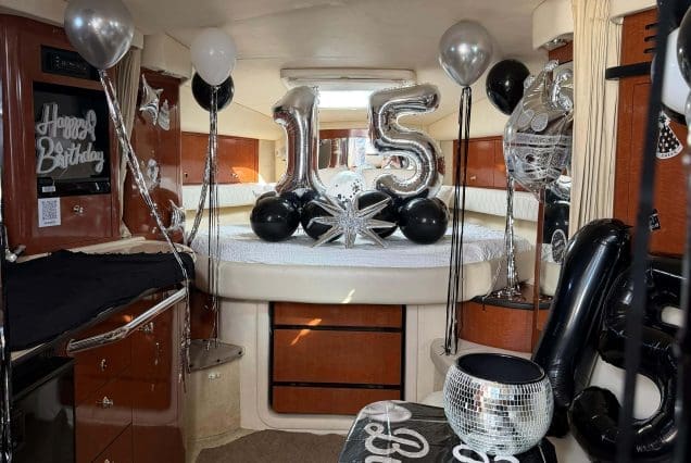 37ft Sea Ray E$Z Miami welcoming indoor salon with comfortable seating and modern styling and birthday decorations