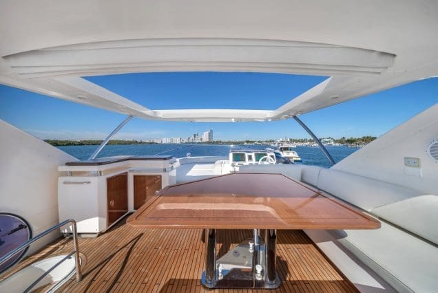 Luxury 70ft Azimut Miami upper deck seating with table for cocktails, dining, and celebrations