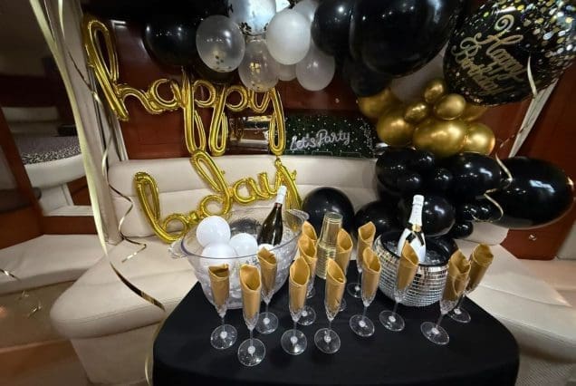 37ft Sea Ray E$Z Miami welcoming indoor salon with comfortable seating and modern styling and birthday decorations
