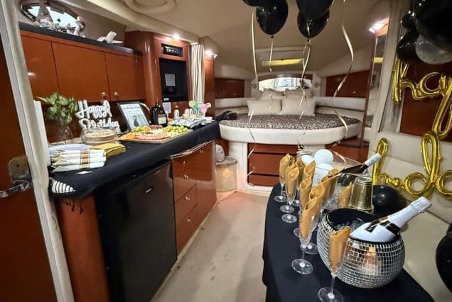 37ft Sea Ray E$Z Miami welcoming indoor salon with comfortable seating and modern styling and birthday decorations