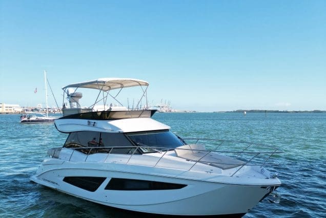 45ft Regal Model 2022 Miami bow lounge area with stunning views of Biscayne Bay and the Miami skyline