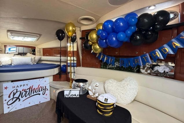 37ft Sea Ray E$Z Miami welcoming indoor salon with comfortable seating and modern styling and birthday decorations